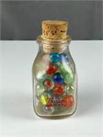 Borden’s Milk bottle with vintage marbles