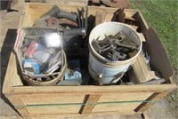 Crate full of implement parts including cutter