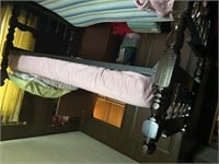 Twin size bunkbed with sheets, pillows, and