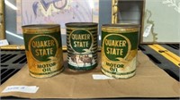 Three cans of Quaker State motor oil
