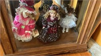 (3) porcelain dolls on bottom shelf