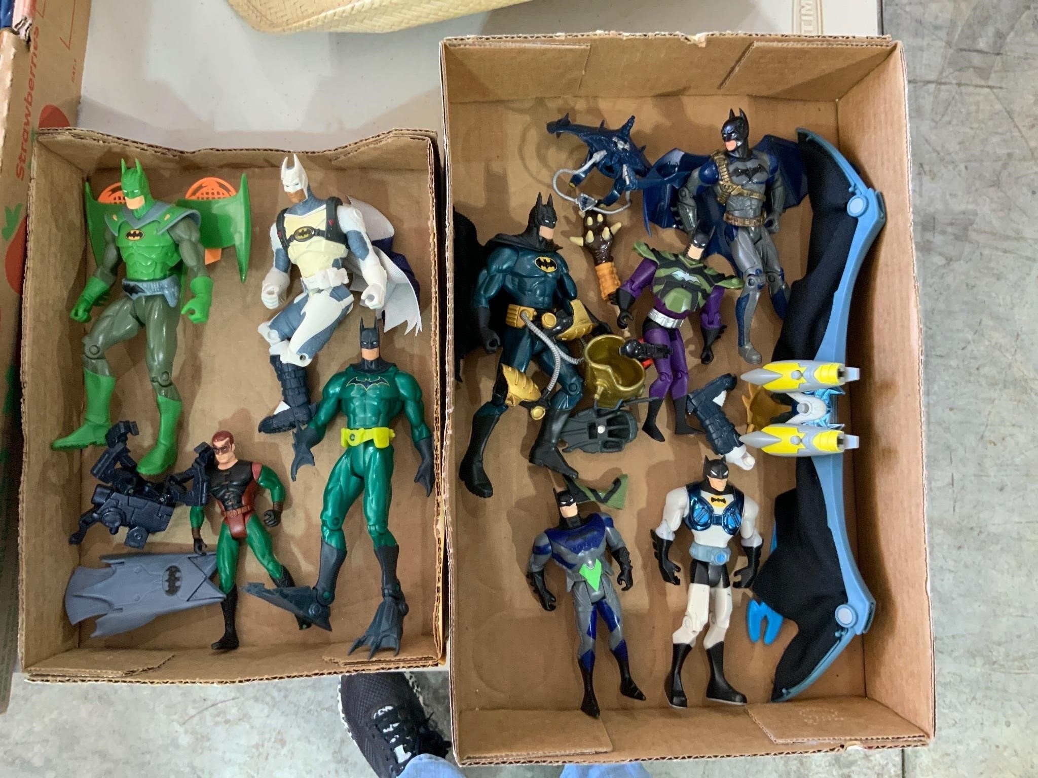 two boxes of batman figurines