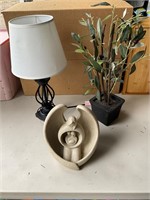lamp, plants, and Herco gift statue