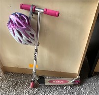 Pink razor, folding scooter and helmet.