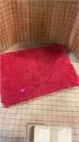 Small red bath rug
