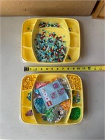 Two containers of Lego dots