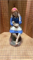 Girl holding dog statue