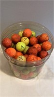 100 colored golf balls, yellow and orange, some