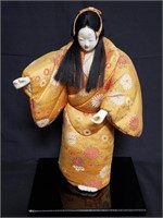 Geisha doll on wooden base