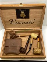 Lot of four smoking pipes and a leather tobacco