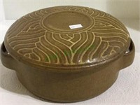 Pottery bowl with two handles and covered lid.
