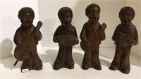 Carved wooden figures of short haired boys with