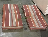 Two outdoor patio cushions appear to be in like