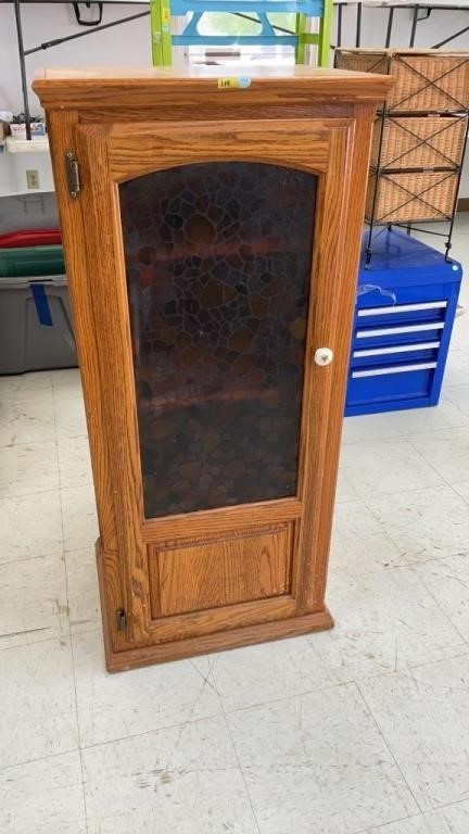 Cabinet with plastic looking stained glass door