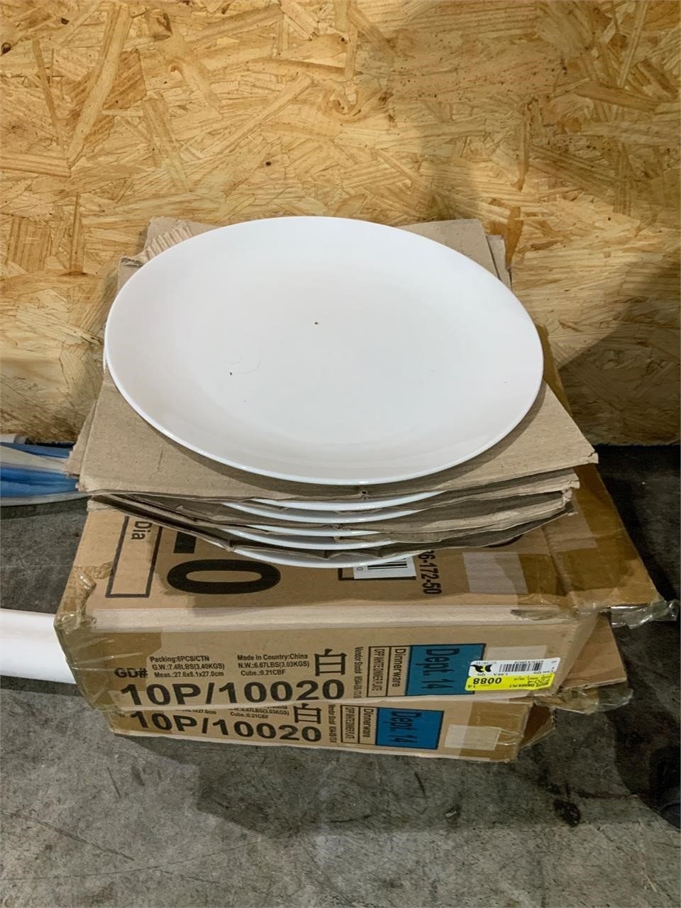 two boxes of new white restaurant plates