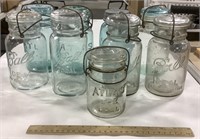 9 glass jars - all glass lids but 1 / 4 blue