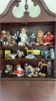Collecter items and Dolls, top three shelves of